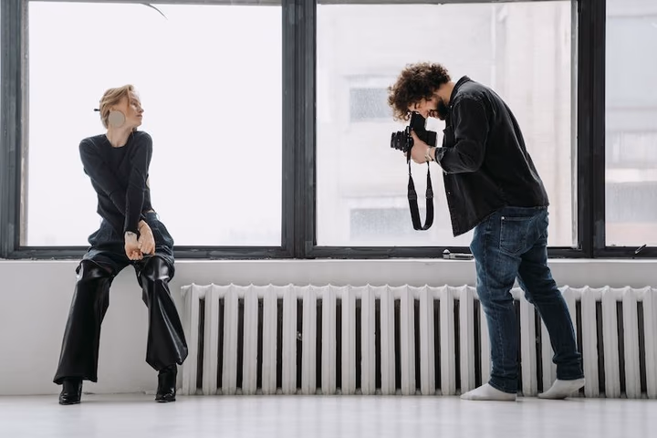 A photographer analyzing portrait settings outdoors