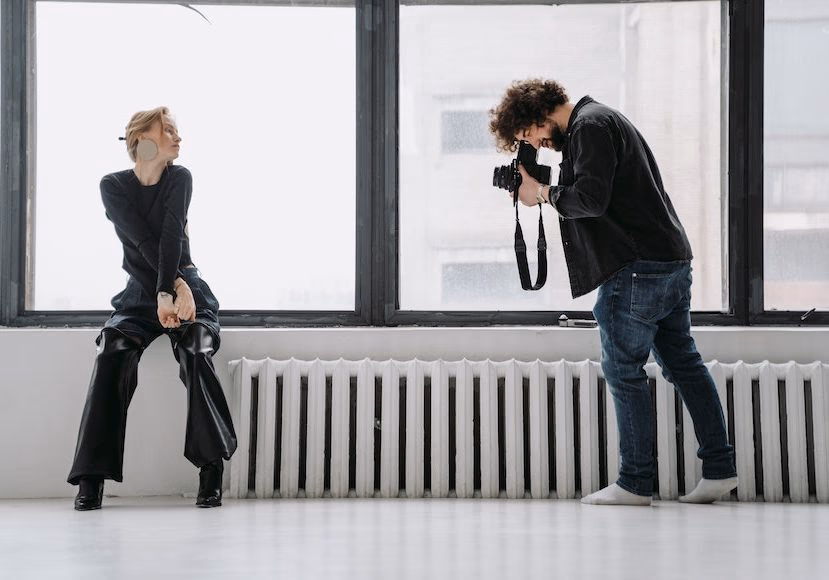 A photographer analyzing portrait settings outdoors